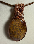 Fossil Coral & Garnet copper wire-wrapped pendant