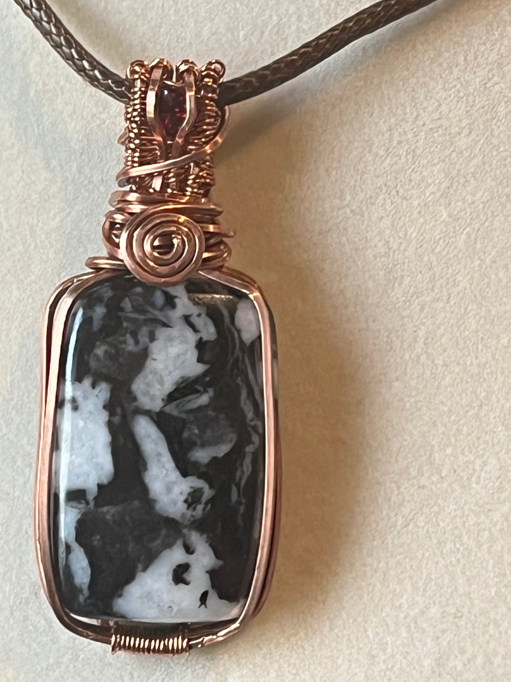 Zebra Jasper copper wire-wrapped pendant with garnet facet