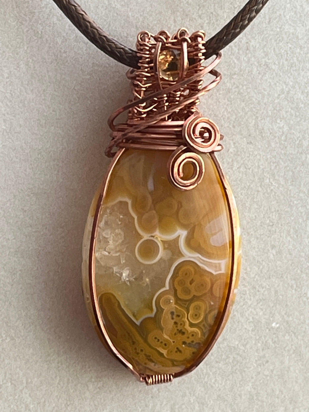 Crazy Lace Agate & Orbicular Jasper copper wire-wrapped pendant with Citrine facet