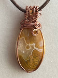 Crazy Lace Agate & Orbicular Jasper copper wire-wrapped pendant with Citrine facet