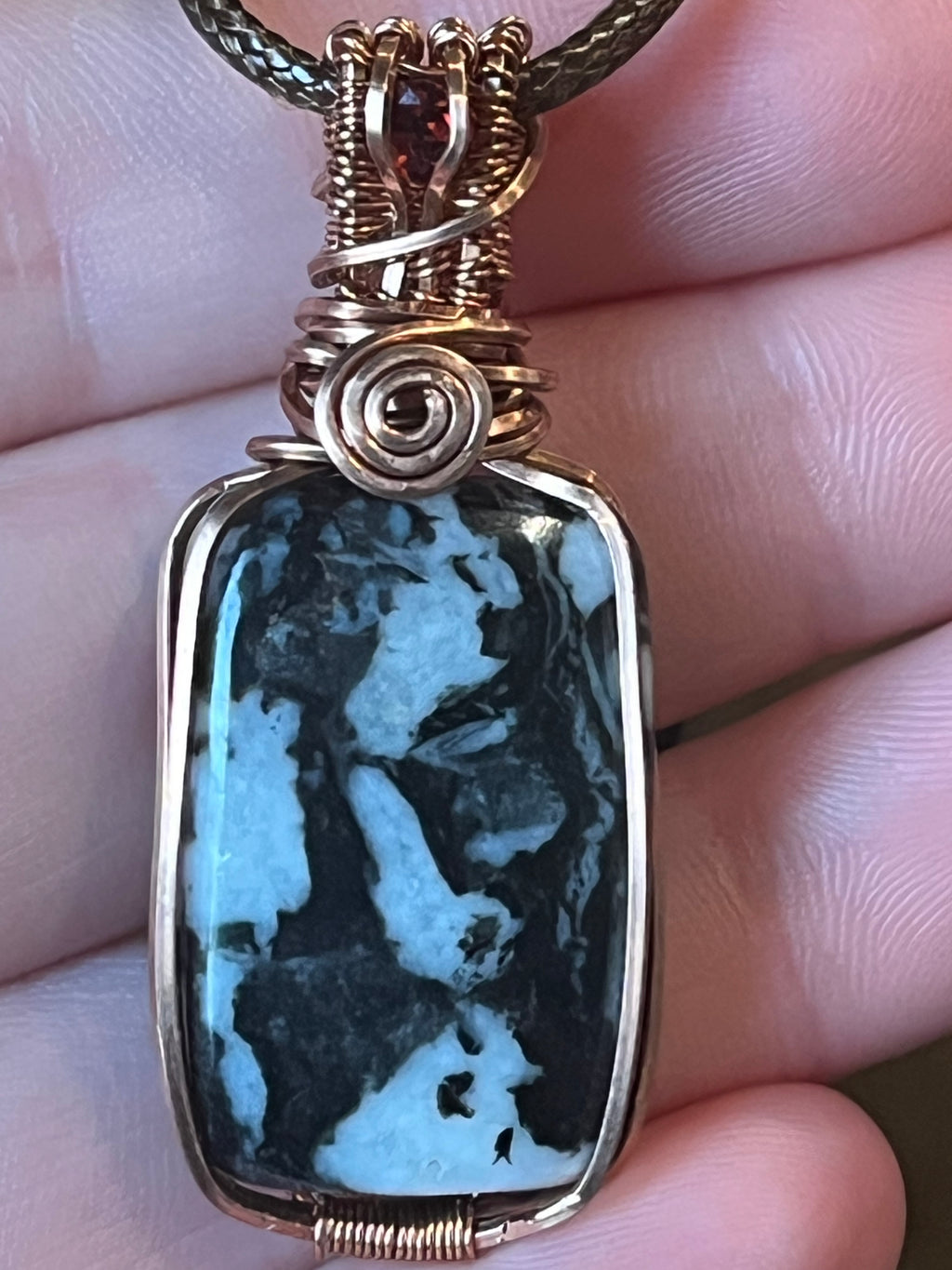 Zebra Jasper copper wire-wrapped pendant with garnet facet