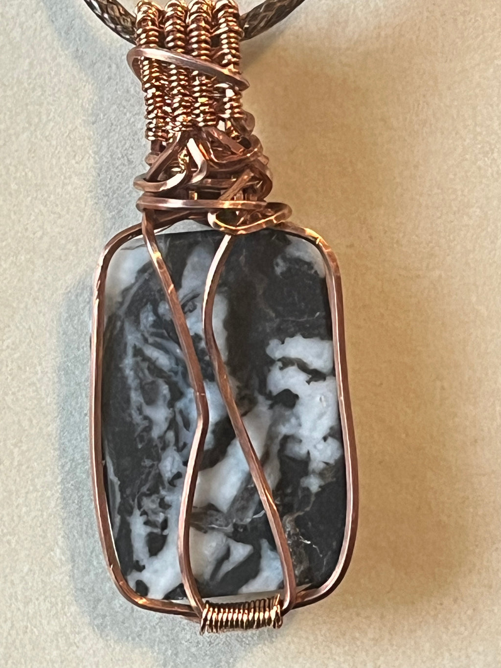 Zebra Jasper copper wire-wrapped pendant with garnet facet