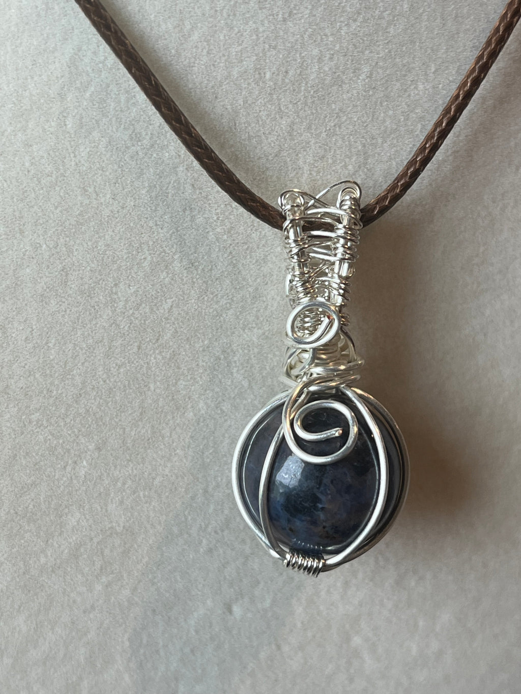 Sodalite sphere silver-tone coated copper wire-wrapped pendant