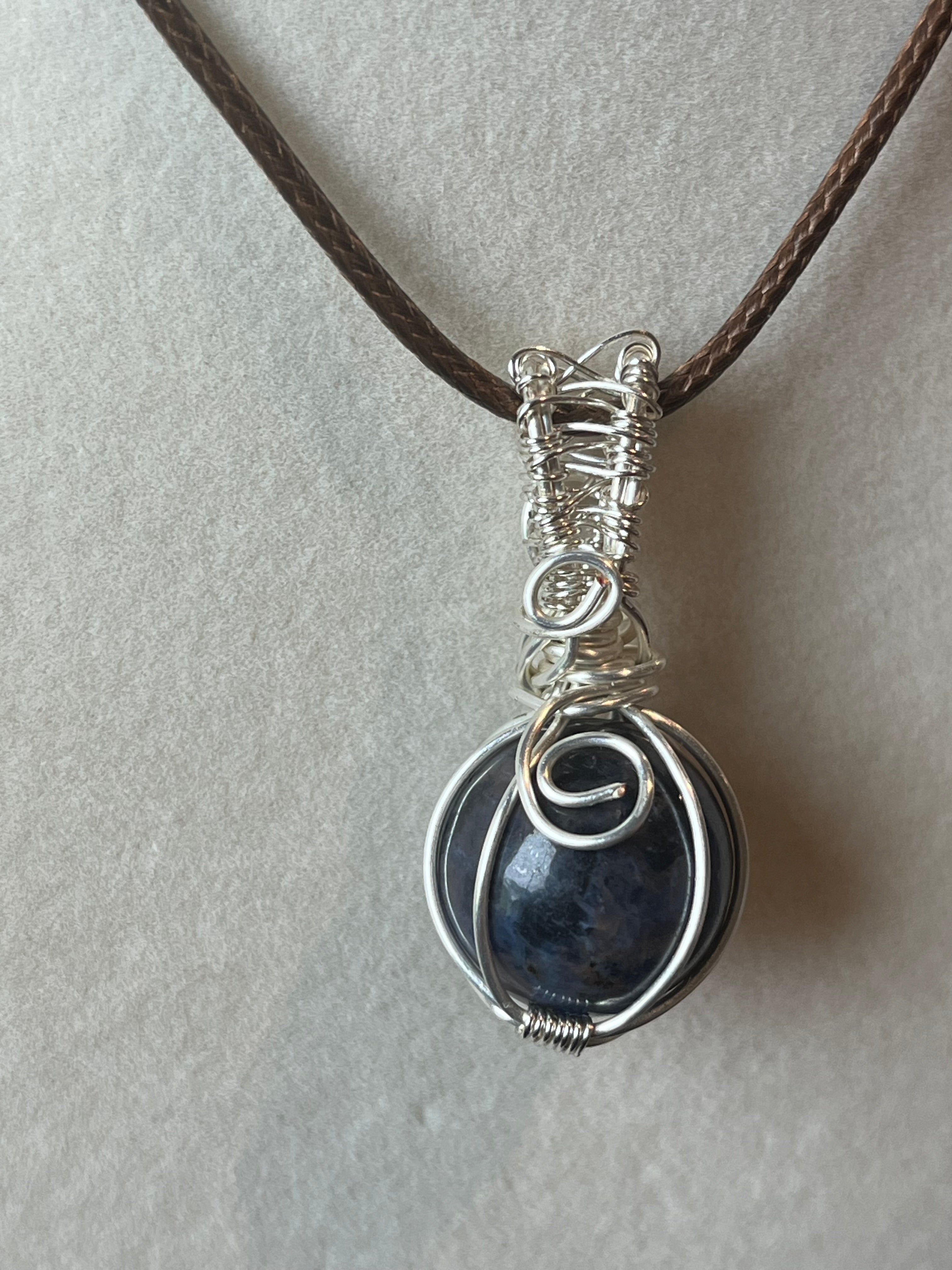 Sodalite sphere silver-tone coated copper wire-wrapped pendant